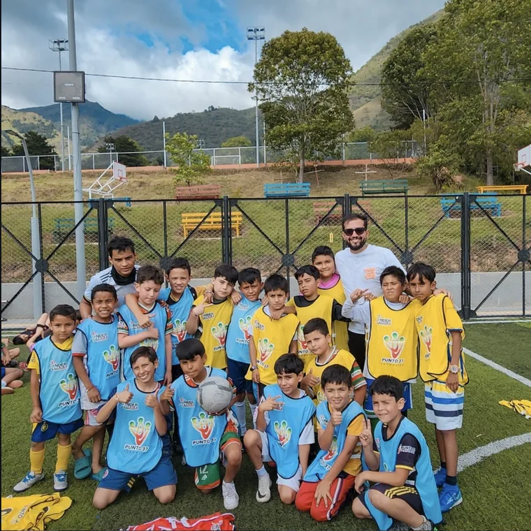 Equipo de niños y niñas con petos de la fundación en una cancha